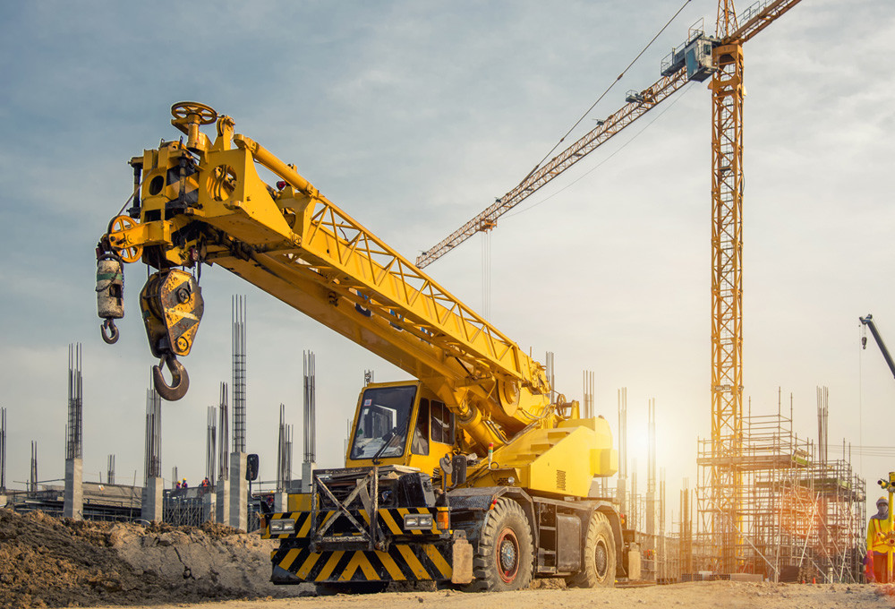 Mobile and tower cranes symbolizing MicroControl solutions for construction machinery